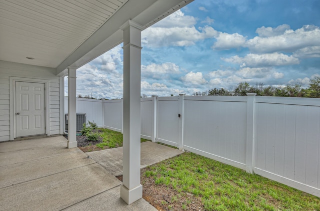 view of yard with central AC and a patio