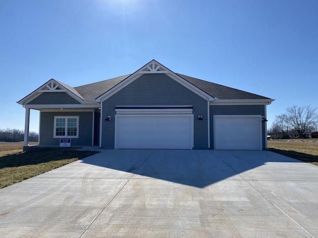 view of front of house featuring a garage and a front lawn