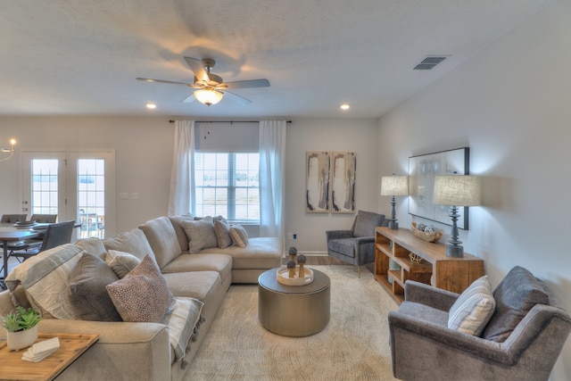 living room with ceiling fan and french doors