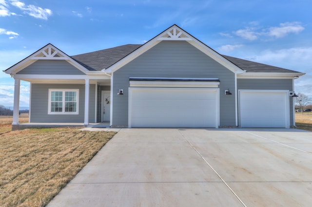 view of front of home featuring a garage and a front yard