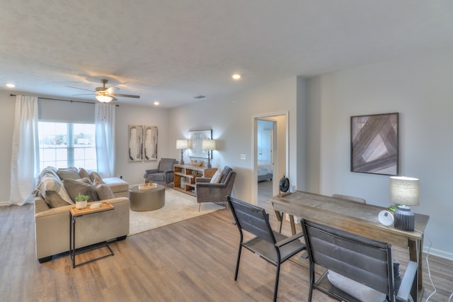 living room featuring ceiling fan and hardwood / wood-style floors