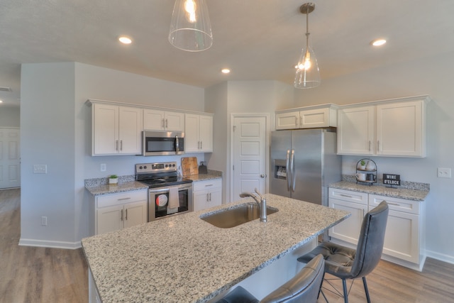 kitchen with light wood-type flooring, white cabinetry, and appliances with stainless steel finishes