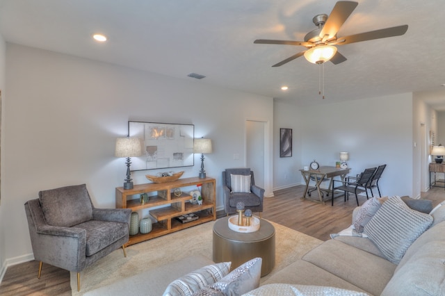 living room featuring hardwood / wood-style floors and ceiling fan