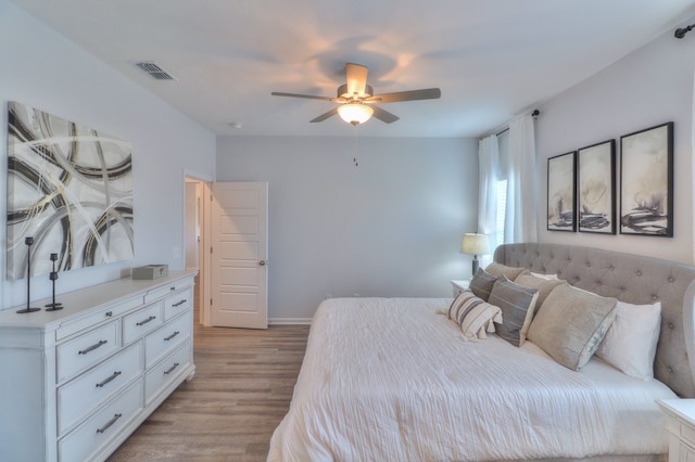 bedroom with ceiling fan and light wood-type flooring