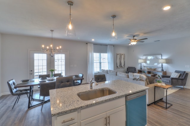 kitchen with white cabinets, hardwood / wood-style flooring, a healthy amount of sunlight, sink, and dishwasher