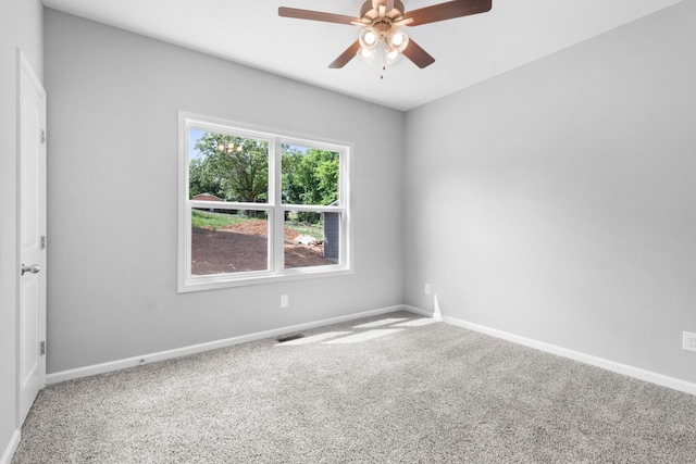 carpeted spare room with ceiling fan