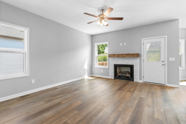 unfurnished living room featuring hardwood / wood-style flooring and ceiling fan