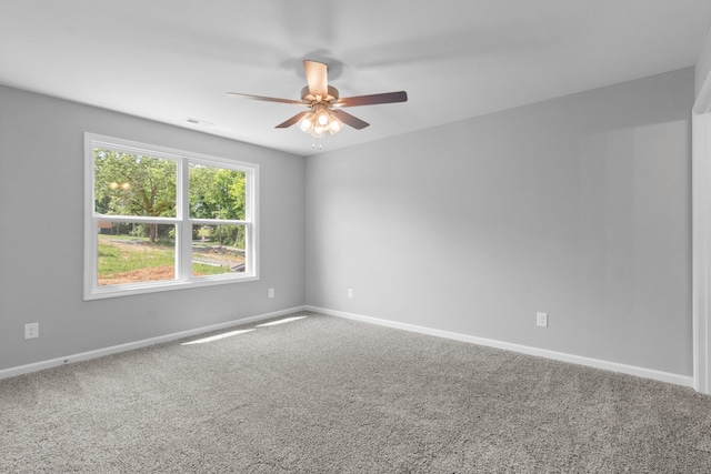 empty room with ceiling fan and carpet floors