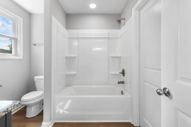 full bathroom with vanity, hardwood / wood-style floors, toilet, and washtub / shower combination