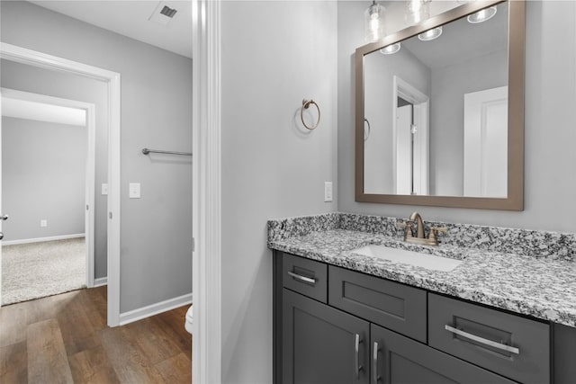 bathroom with vanity and hardwood / wood-style floors