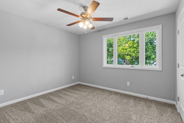 carpeted spare room with ceiling fan