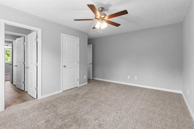 unfurnished bedroom featuring ceiling fan and light colored carpet