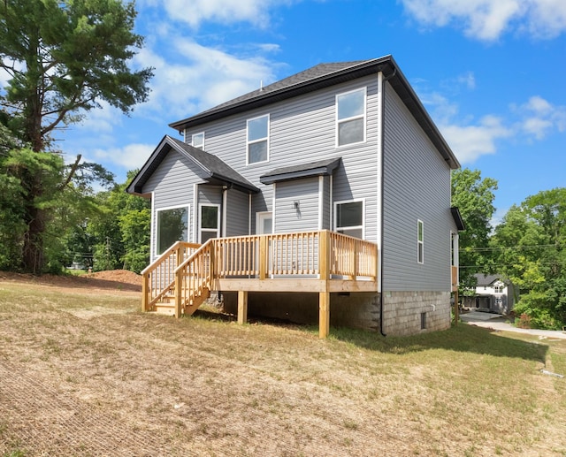 back of house with a wooden deck and a yard