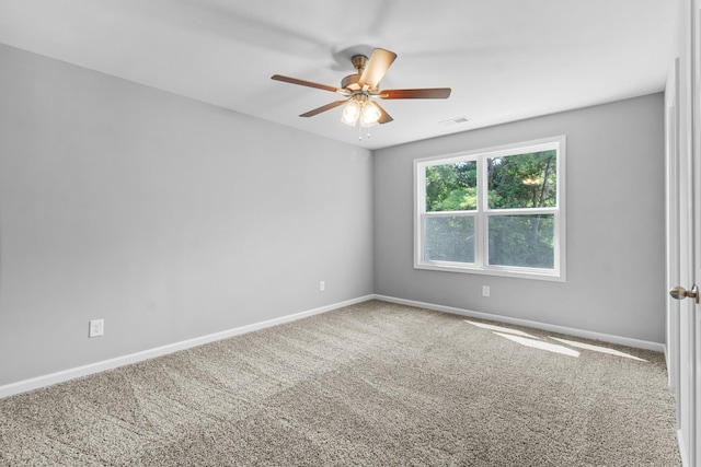 carpeted spare room with ceiling fan