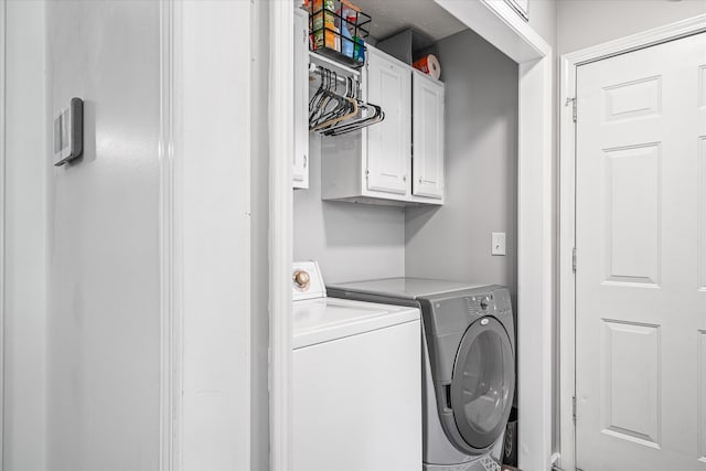 laundry room with cabinets and washing machine and dryer