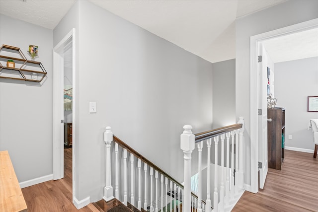 corridor with hardwood / wood-style flooring