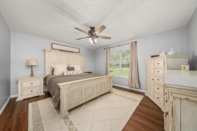 bedroom with a textured ceiling, wood-type flooring, and ceiling fan