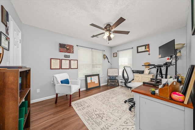 home office featuring a textured ceiling, ceiling fan, and hardwood / wood-style floors