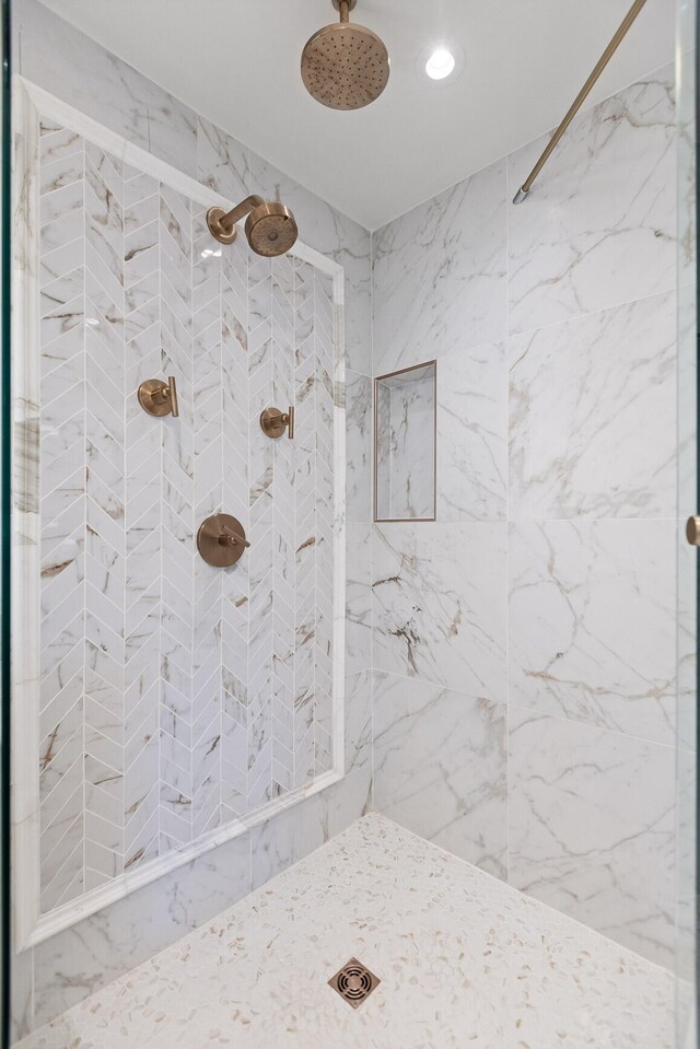 bathroom with a tile shower