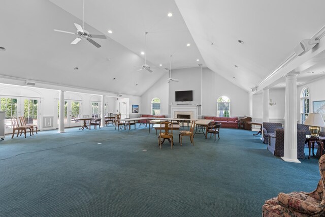 dining space featuring ceiling fan, french doors, ornate columns, carpet, and high vaulted ceiling