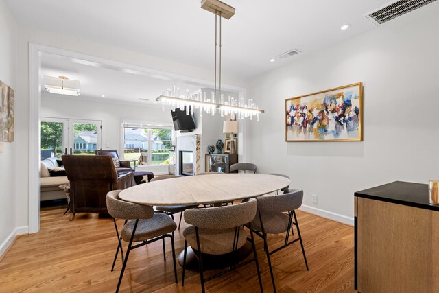 dining area with light hardwood / wood-style flooring and french doors