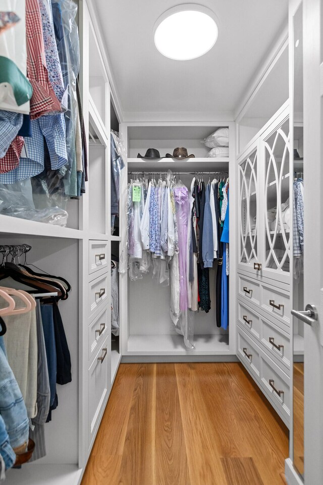 walk in closet featuring light hardwood / wood-style flooring