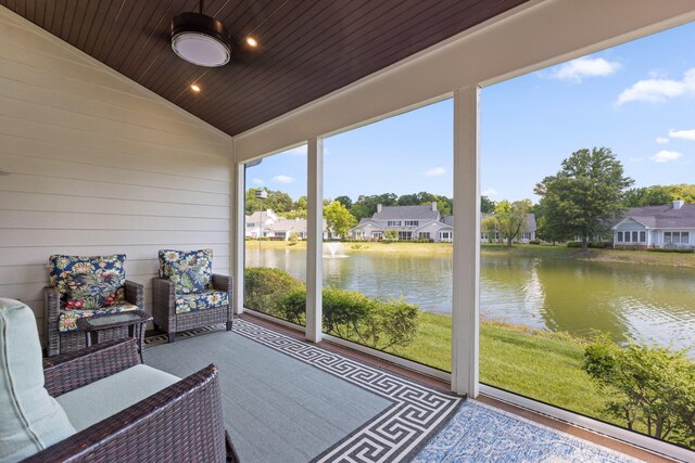 unfurnished sunroom with vaulted ceiling, a water view, and wood ceiling