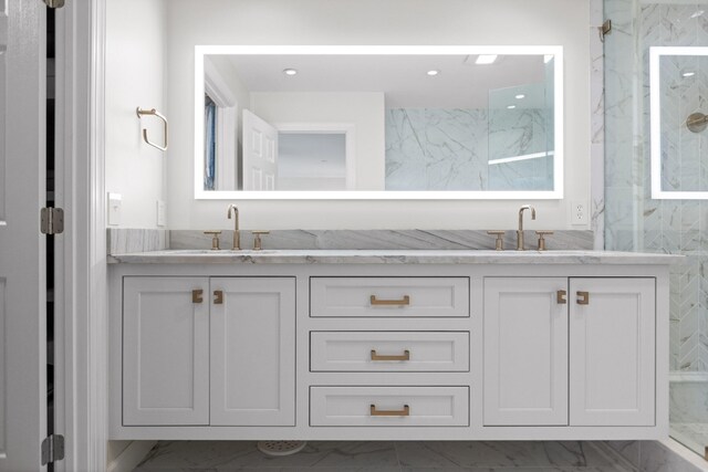 bathroom featuring tile flooring, walk in shower, and vanity