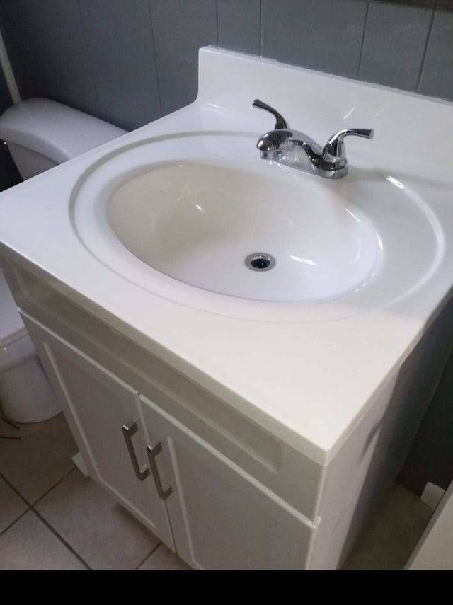 bathroom featuring vanity, toilet, and tile floors