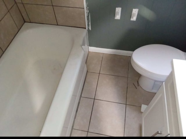 bathroom with tile floors, toilet, and vanity