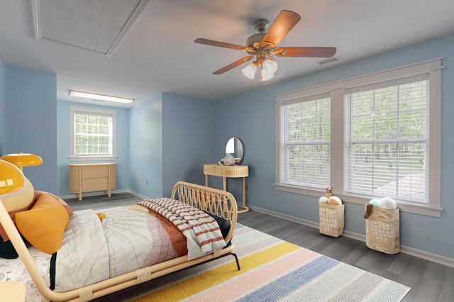 bedroom with ceiling fan and dark hardwood / wood-style flooring