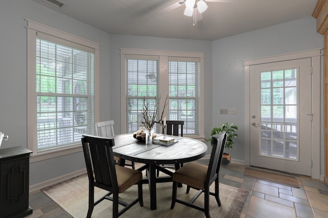 tiled dining space featuring ceiling fan