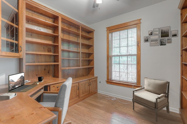 home office with ceiling fan and light hardwood / wood-style flooring