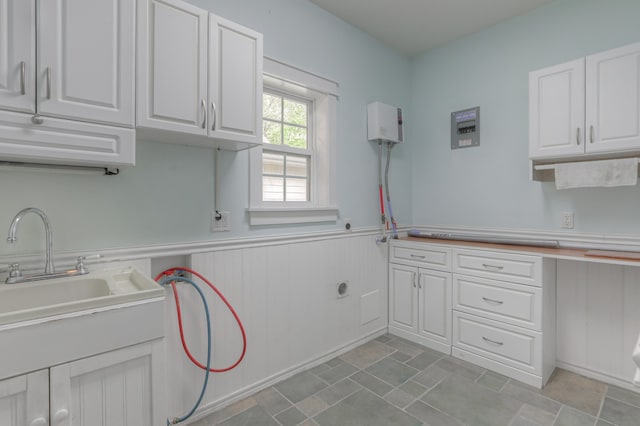 kitchen featuring white cabinets and light tile floors