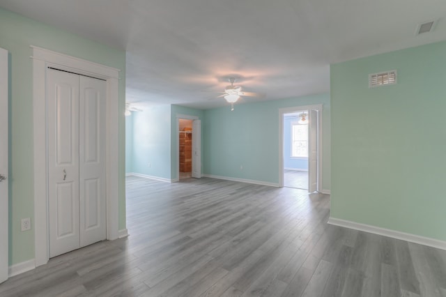 empty room with hardwood / wood-style floors and ceiling fan