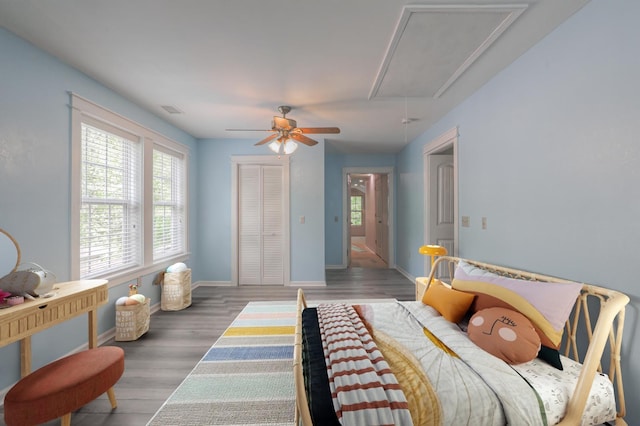 bedroom with ceiling fan, a closet, and hardwood / wood-style flooring