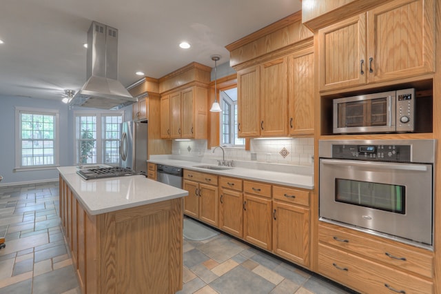 kitchen featuring island exhaust hood, tasteful backsplash, stainless steel appliances, decorative light fixtures, and sink