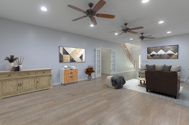 living room featuring ceiling fan and light wood-type flooring