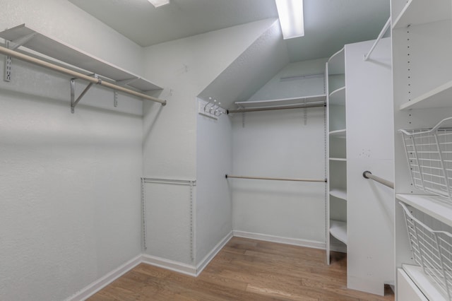 spacious closet featuring hardwood / wood-style flooring