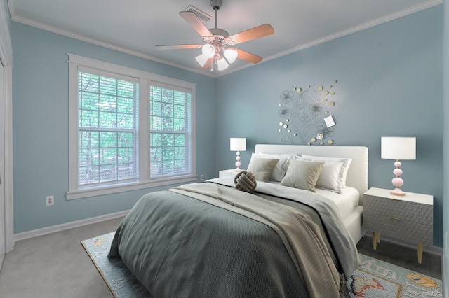 carpeted bedroom with ceiling fan and ornamental molding