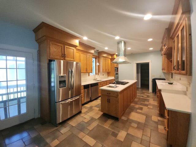 kitchen featuring stainless steel appliances, a center island with sink, island range hood, and dark tile flooring