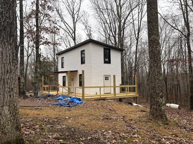 rear view of property with a wooden deck