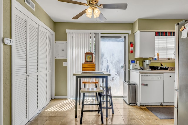 kitchen with white appliances, white cabinets, ceiling fan, and light tile floors