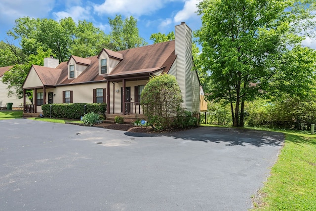 new england style home with a porch