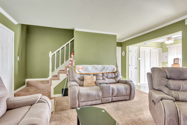 living room with ornamental molding, carpet floors, and ceiling fan