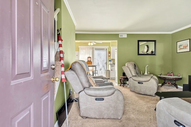 carpeted living room featuring ceiling fan and ornamental molding