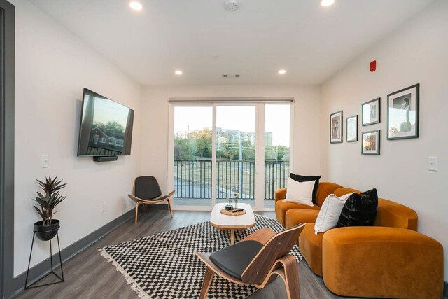 living room with dark hardwood / wood-style flooring