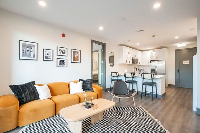 living room featuring sink and light wood-type flooring