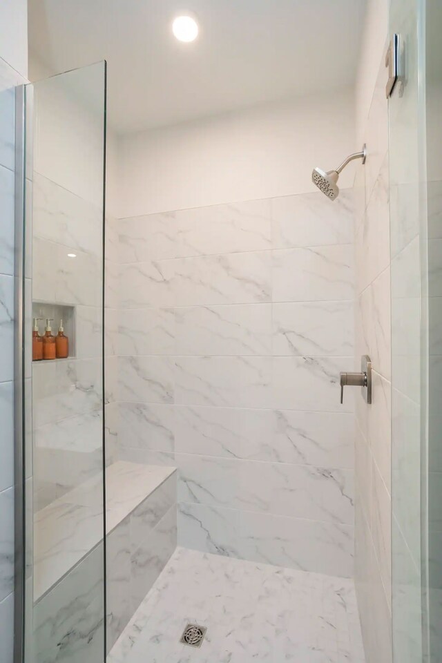 bathroom with a tile shower