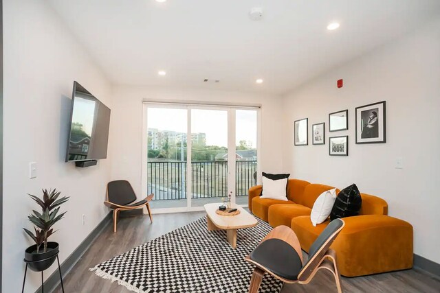 living room with dark hardwood / wood-style flooring